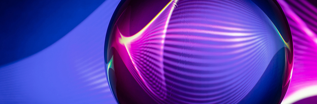 A digital image of an orb with ribbed energy flowing through it. It is in blues and purples.