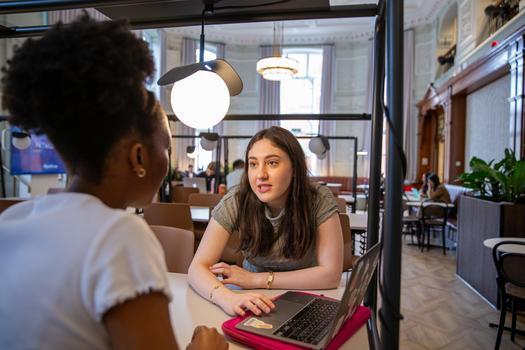 Two student chatting with a laptop