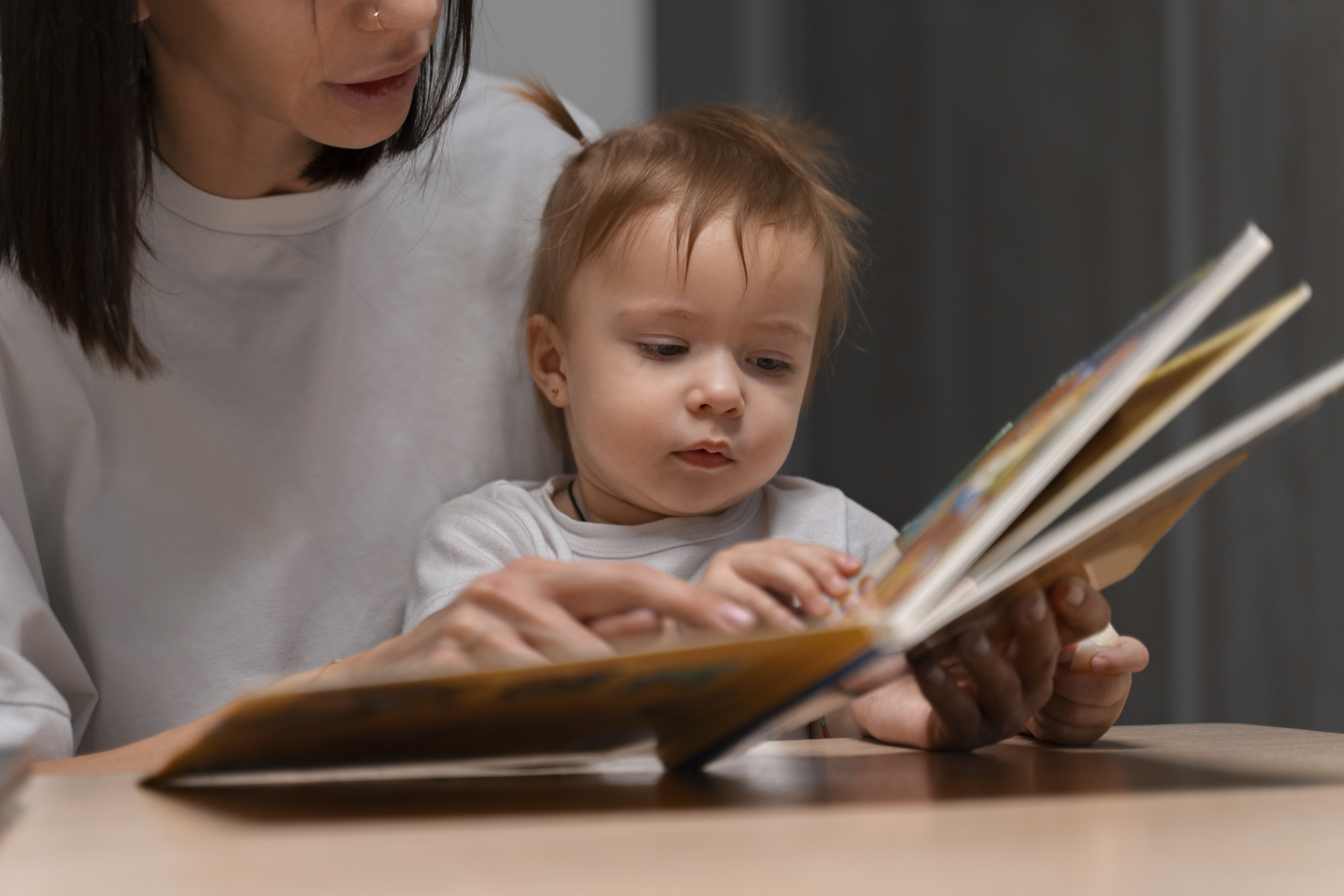 A woman reading to an infant