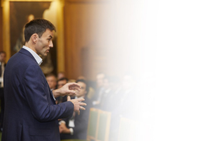 A man delivering a talk to an audience