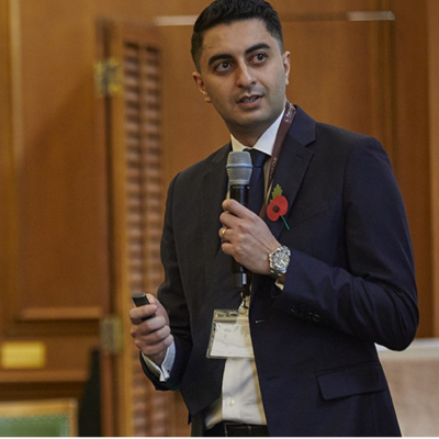 A man giving a talk holding a microphone