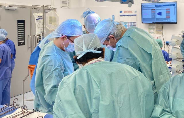 Surgeons operating in theatre
