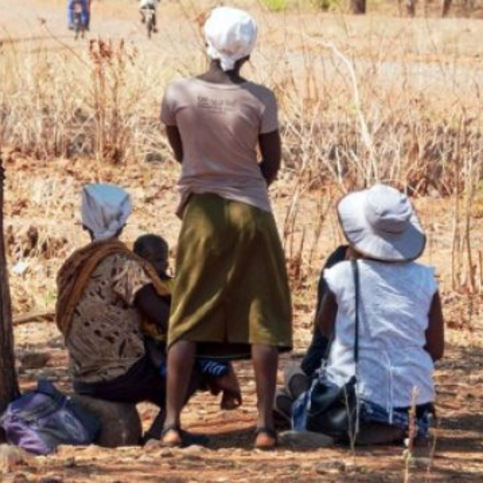 Three women with a child in a rural setting in Zimbabwe
