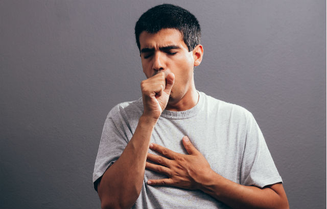 A man coughing