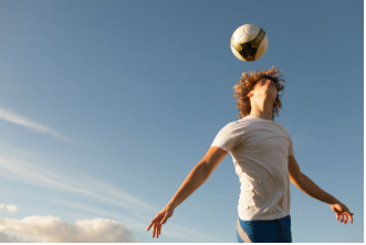 Footballer with a football above his head