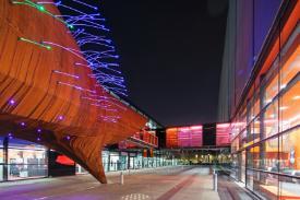Neuron Pod illuminated outside the Blizard building at night