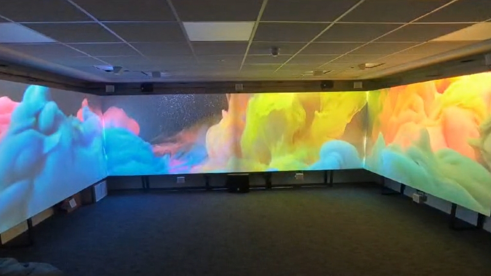 a room with projections across 4 screens