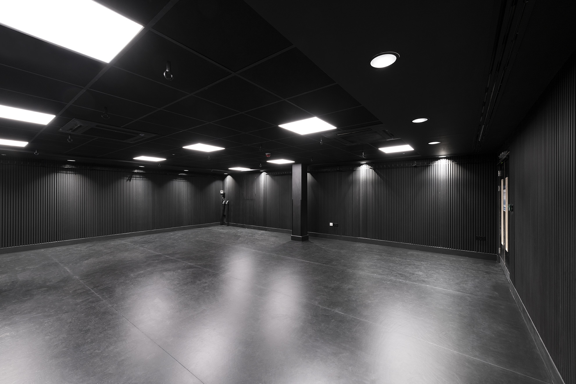 A black box room with bright white lights