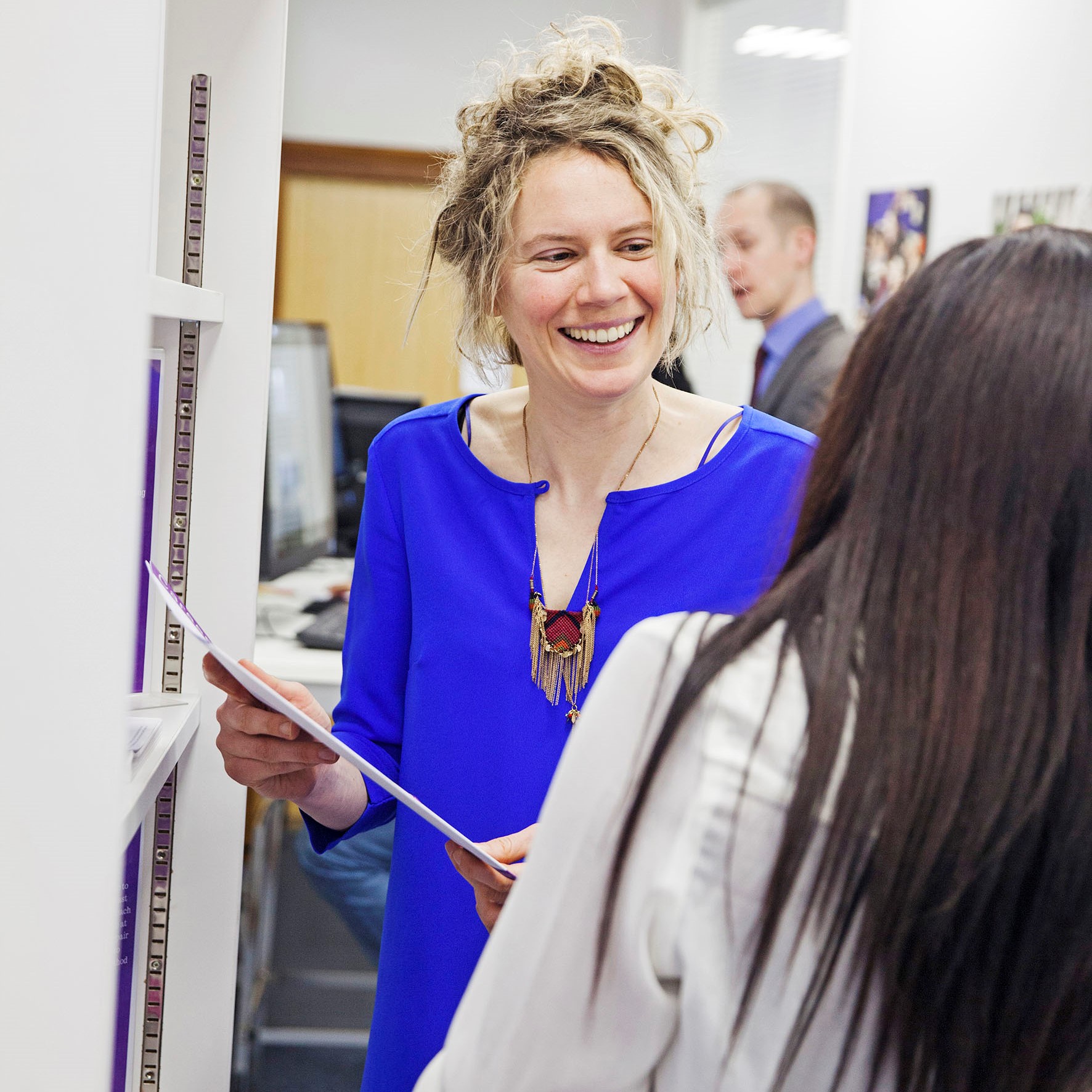 Woman showing student a careers information guide