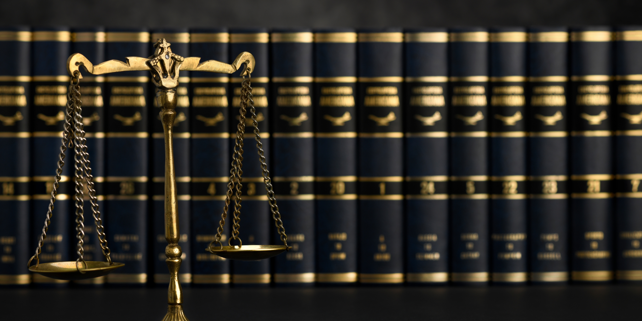 Set of scales in front of legal books