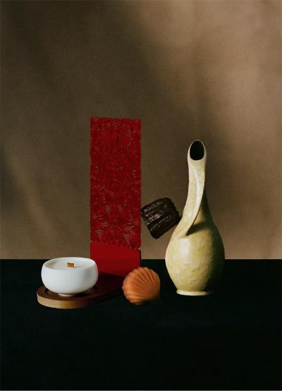 An example of a finished red Miao paper-cutting displayed next to some handmade pottery.