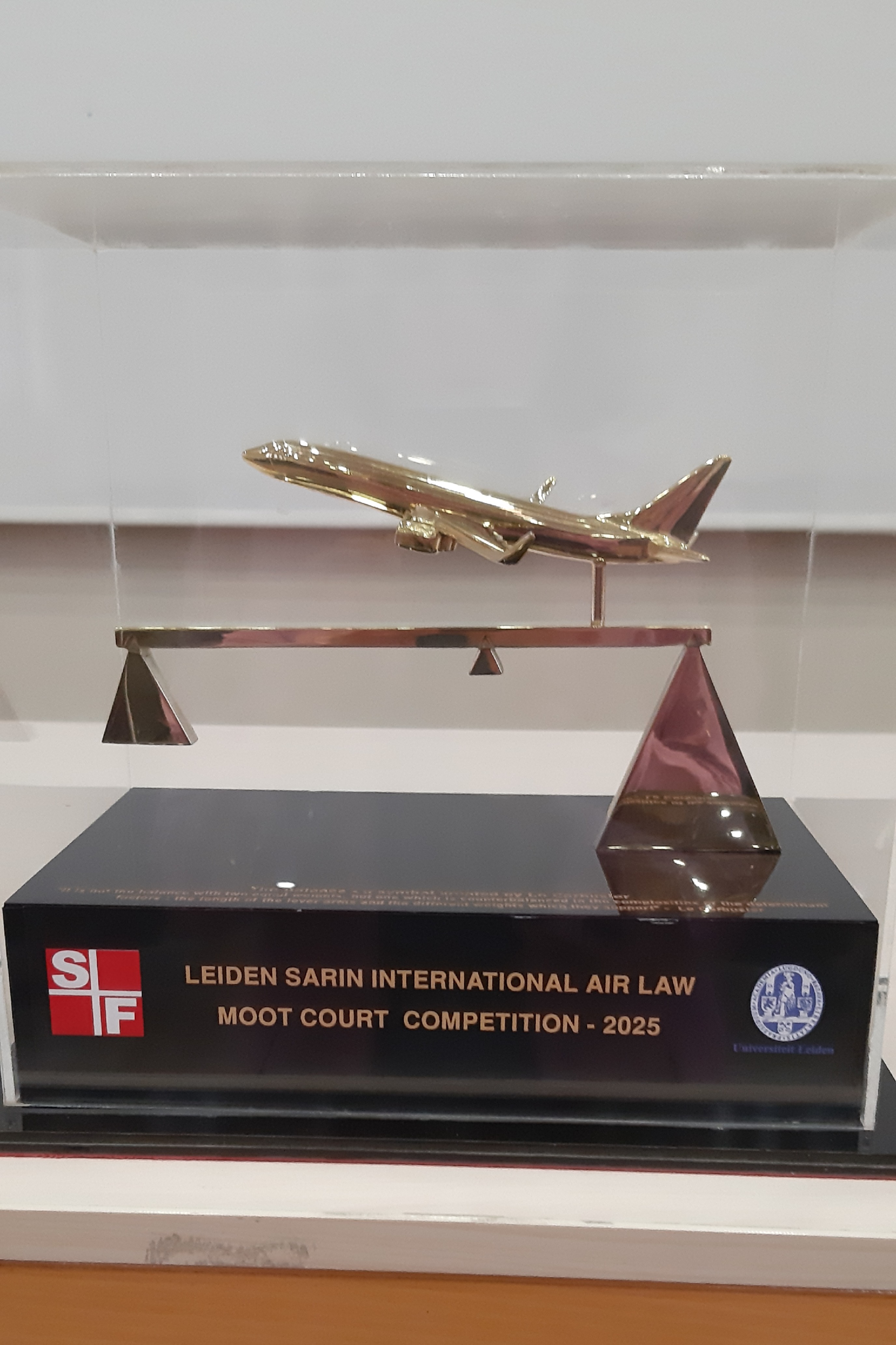 Gold trophy on a wooden plinthe