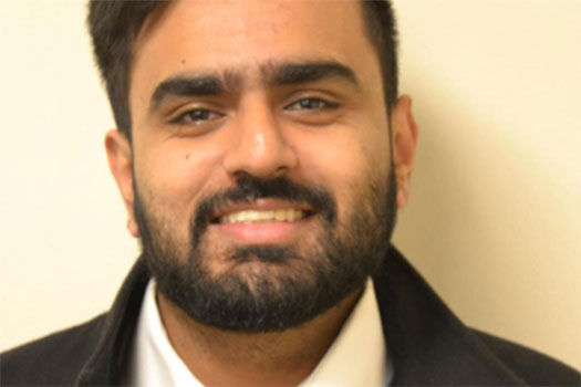Kunal Bindra smiling, wearing a jacket and white shirt