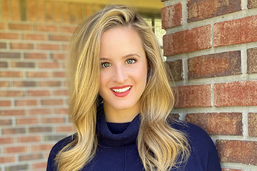 Jennifer Hartzler head and shoulders photo against a brick walll