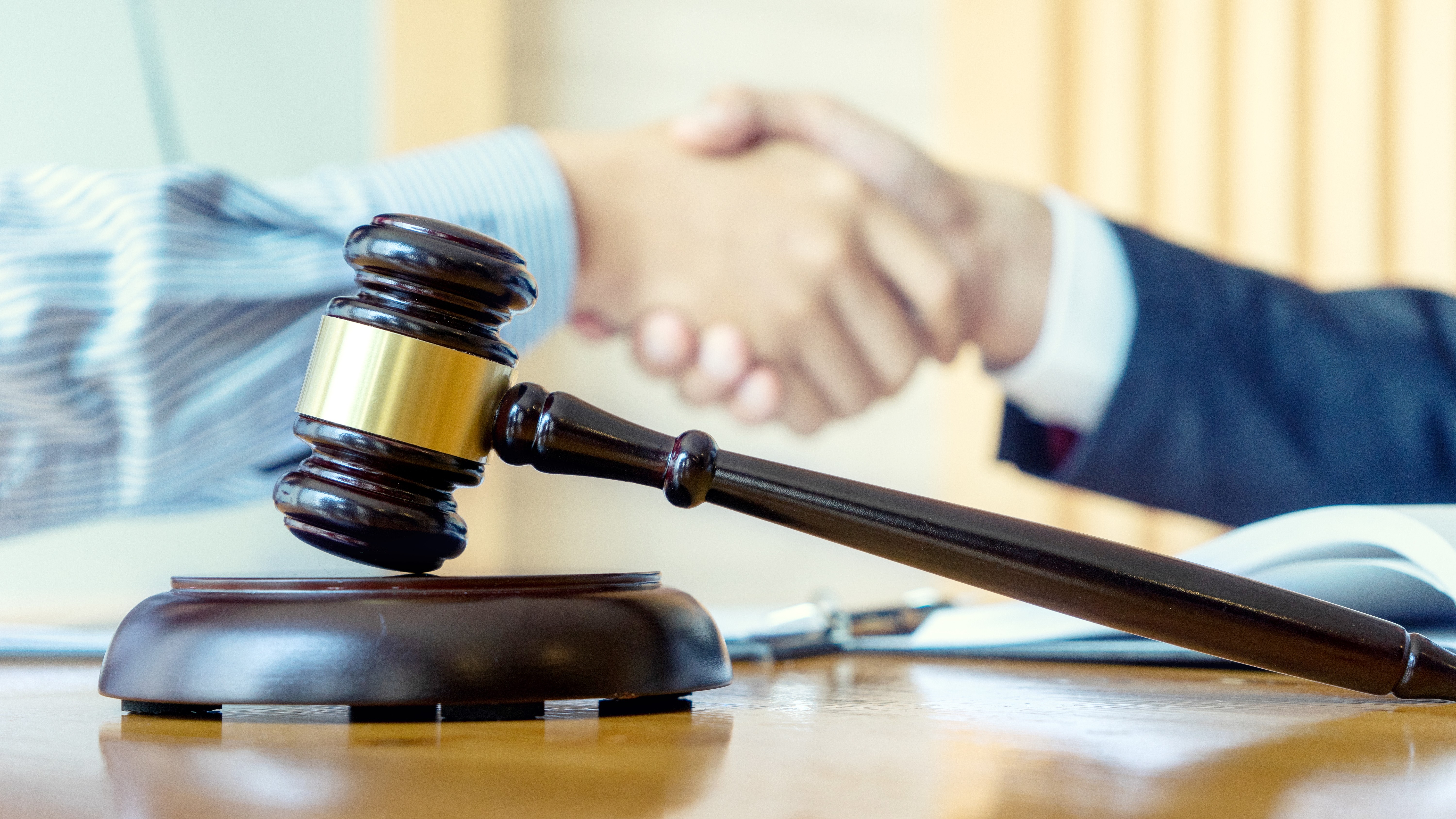 Shaking hands and gavel