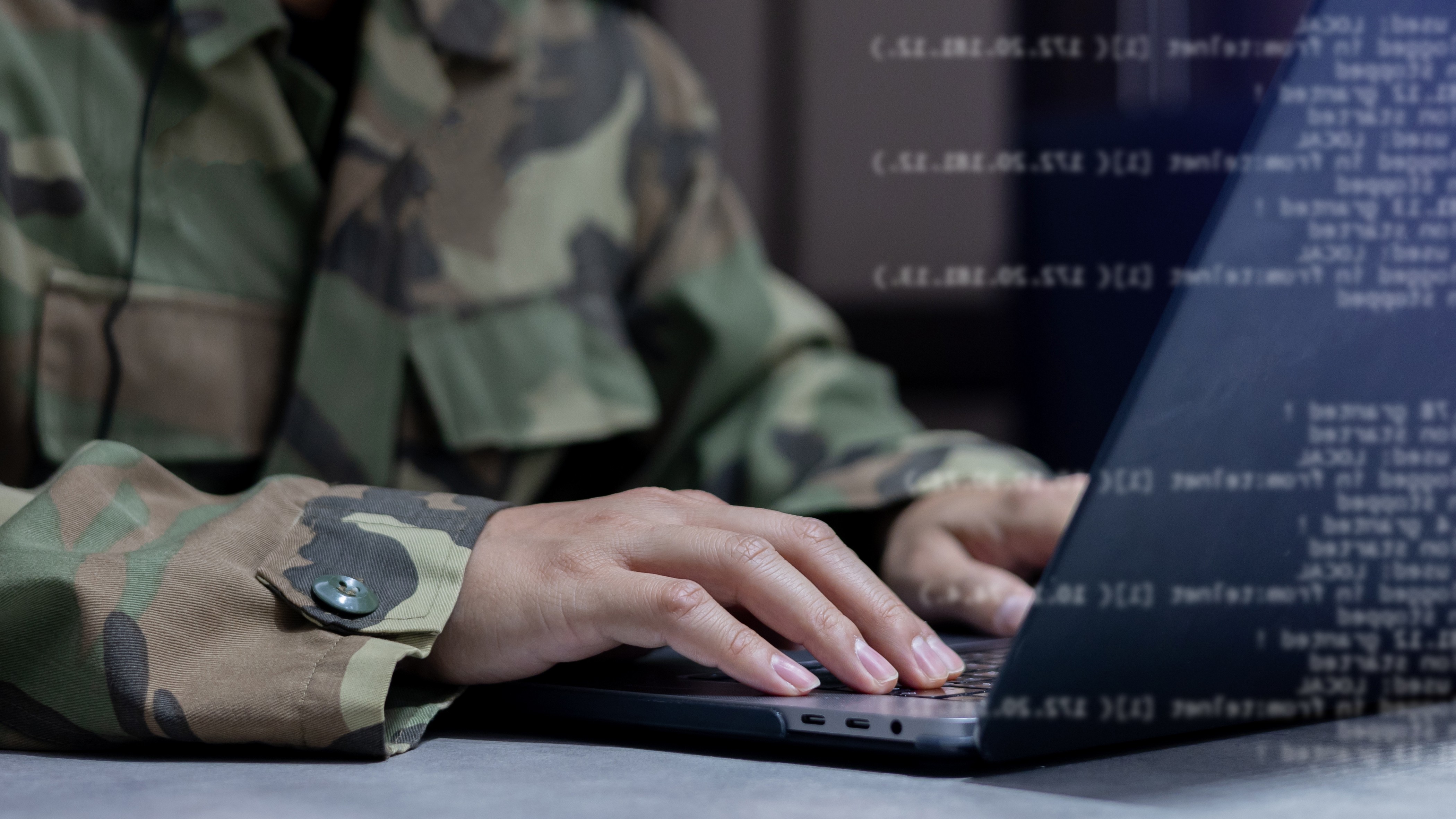 Person in military uniform at computer