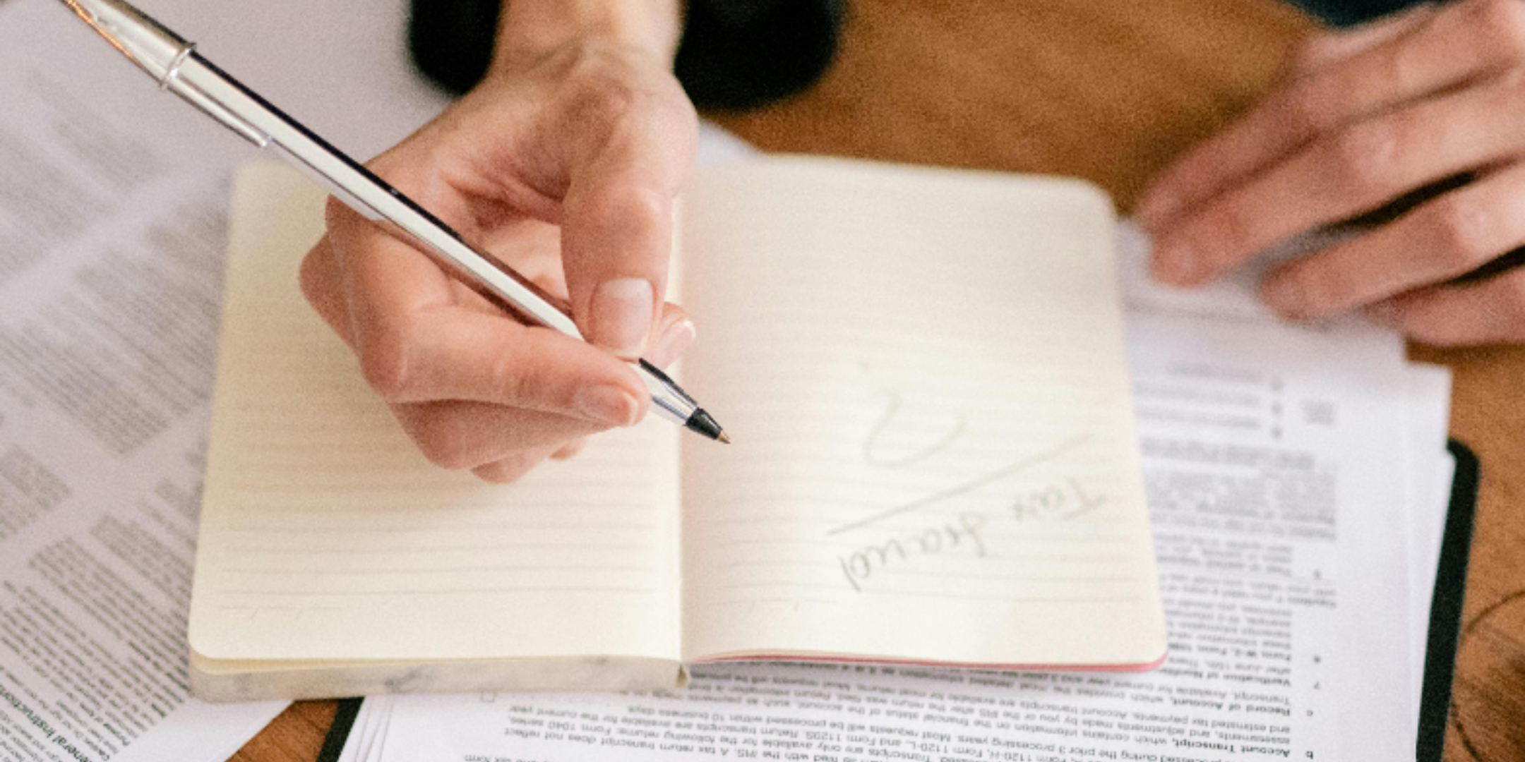 Person writing in a booklet