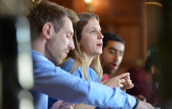three people talking at the table