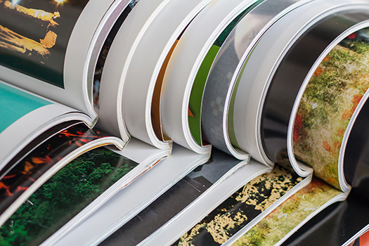 A stack of open magazines.