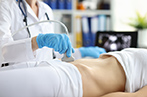 A person having an ultrasound performed on their lower abdomen.