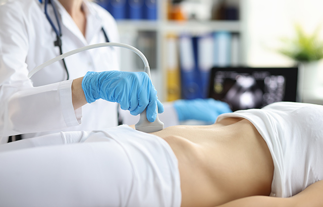 A person having an ultrasound performed on their lower abdomen.