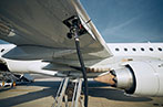 A light aircraft refueling on a runway.