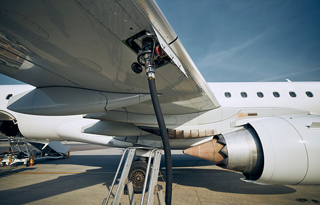 A light aircraft refueling on a runway.