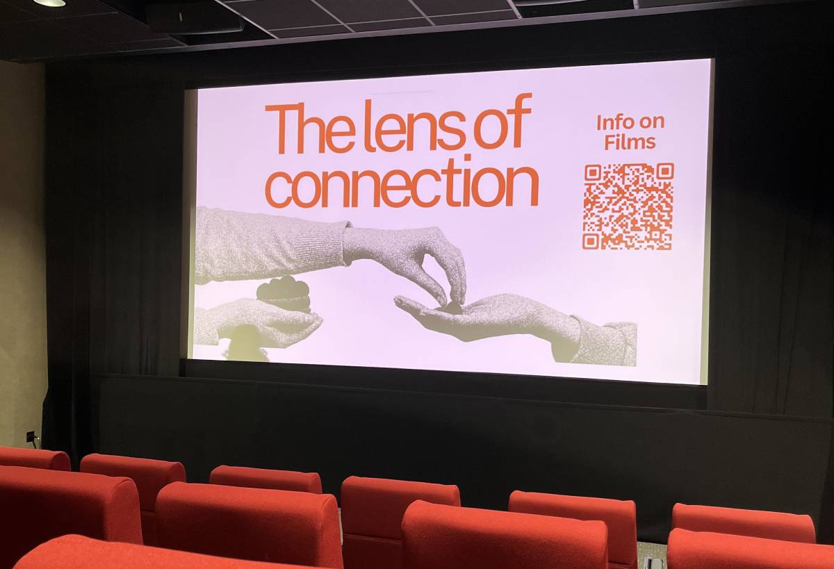 Cinema screen showing poster for student curated film festival