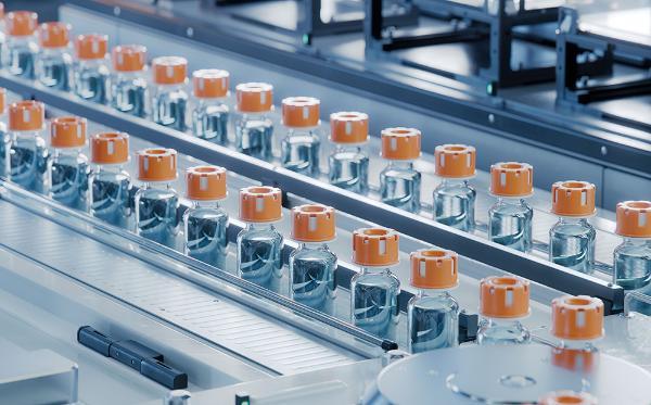 Rows of Glass Vials with Orange Caps on Conveyor Belt at Modern Pharmaceutical Factory.