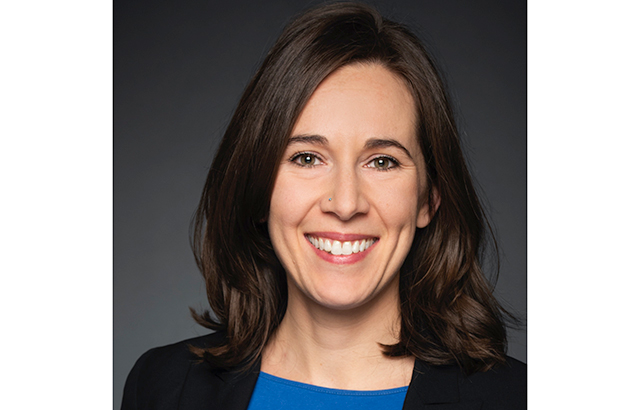Sarah Berger Richardson smiling, wearing a blue top and black blazer.