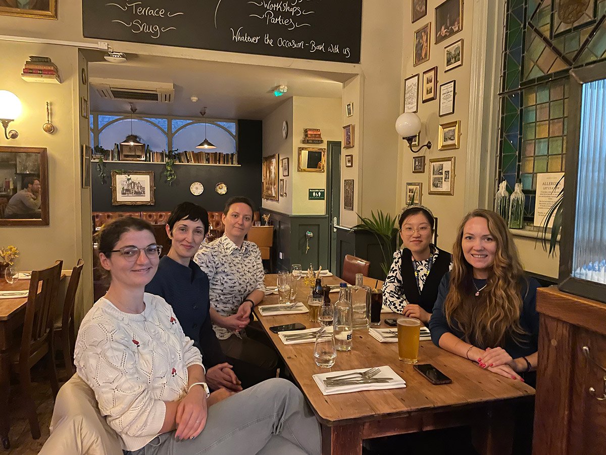 WHEN attendees at a table looking at camera