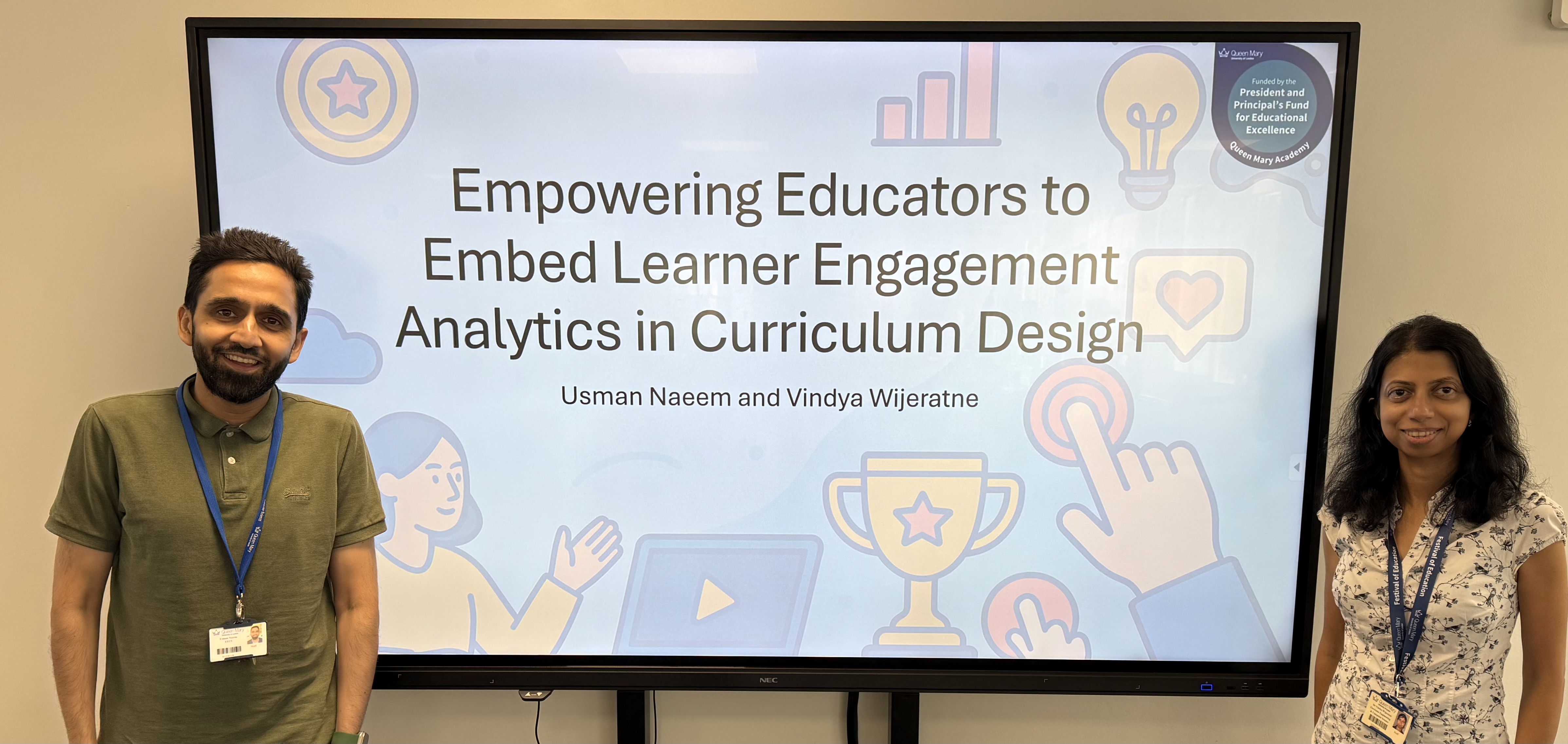 2 EECS academics in front of presentation