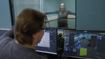 A researcher looking at screen and testing on another researcher