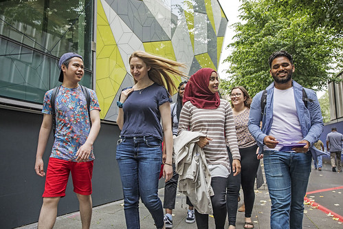 A group of 4 students walking towards the camera