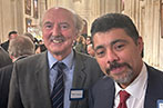 Professor Peter Cameron posing for a photo at an event with another attendee.