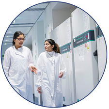 Two students walking in a lab.