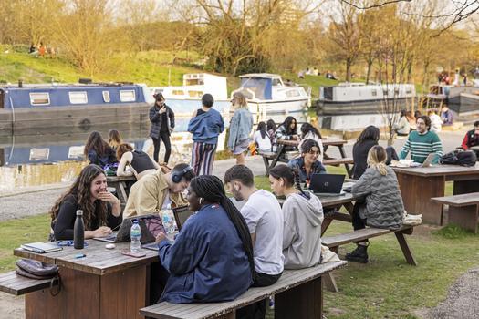 Students sat by the canal