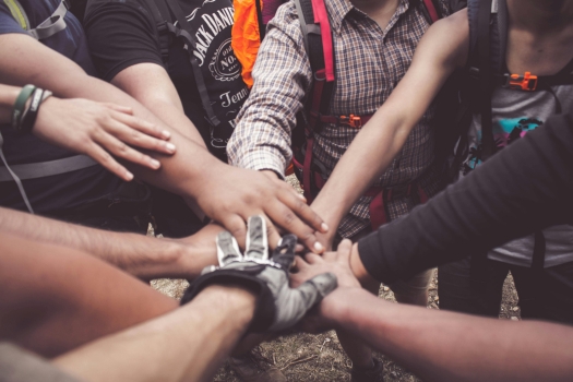 Group of arms and hands in a huddle on top of each other