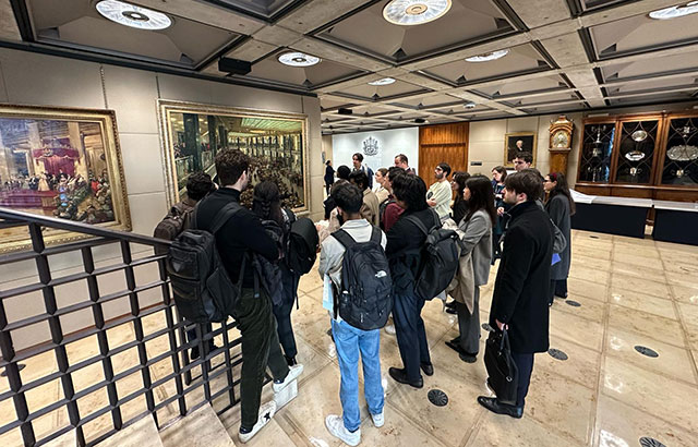 CCLS Students listening to a tour guide speak about Lloyd's of London, whilst getting a tour of their building.