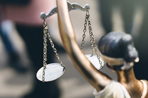 Lady Justice holding scales, blind-folded