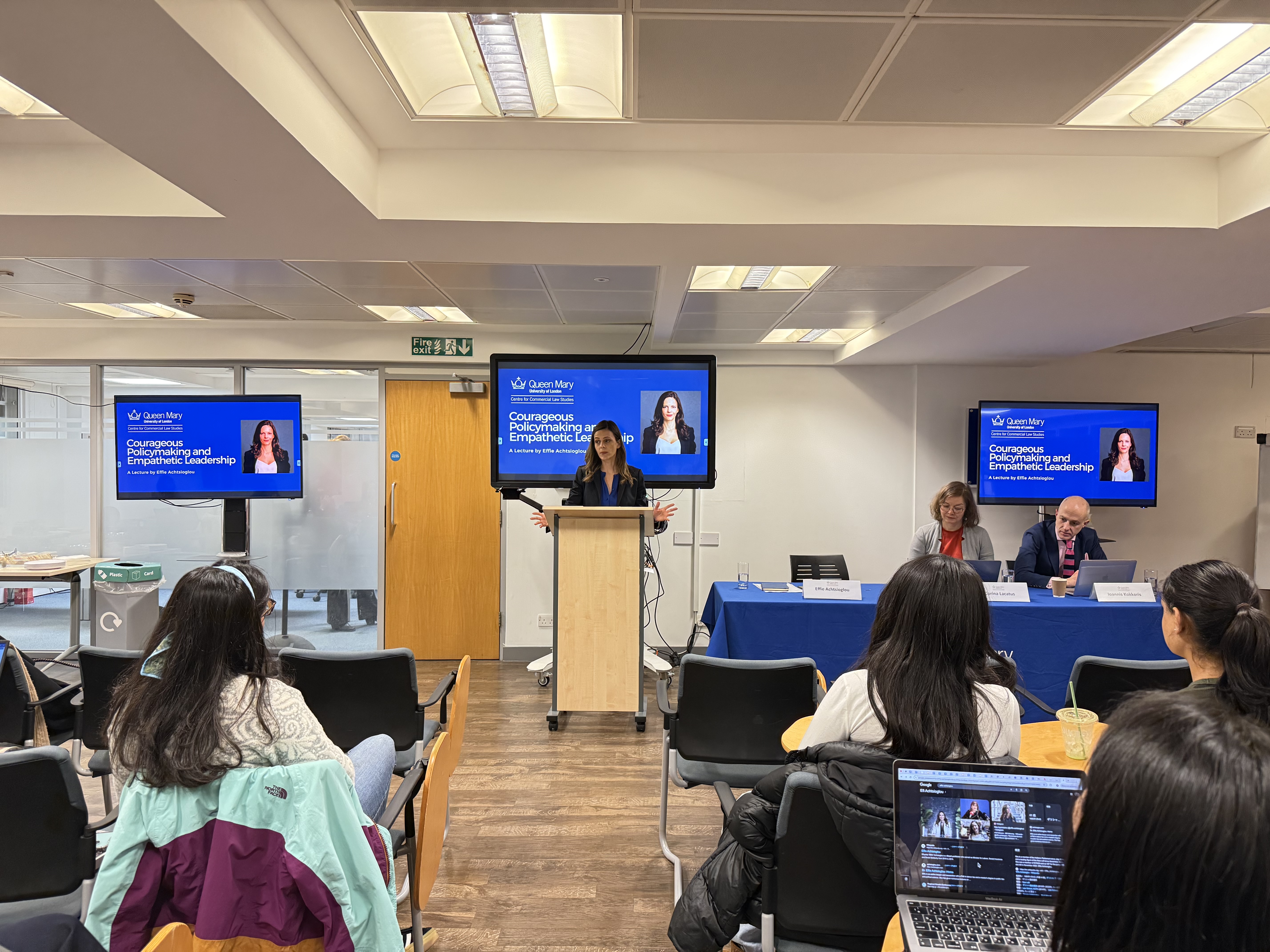 Effie Achtsioglou speaking to a room from a podium