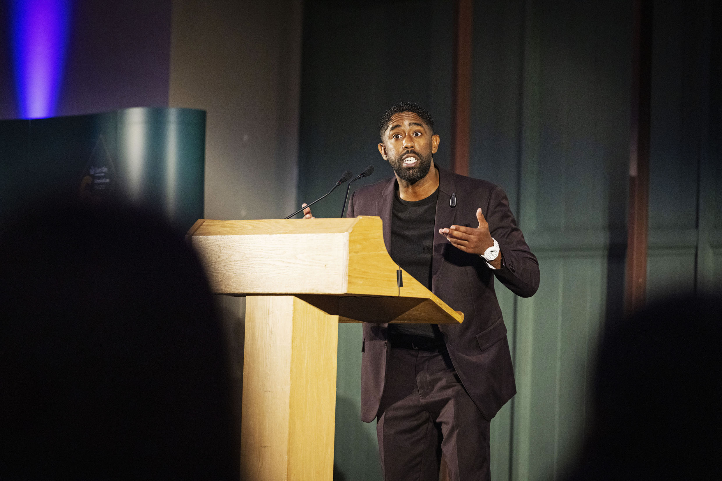 Pen Moodz stood at lectern