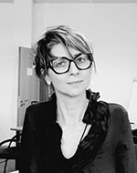 Francesca Albanese. She is wearing glasses and a dark top. The image is in black and white.
