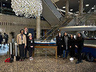 A group of students stood together in a building foyer