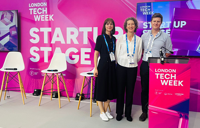 qLegal's Emily Wapples and Eliza Platts-Mills on a podium at Legal Tech Week with Tom Bohills, Founder and Principal at Founders Law.
