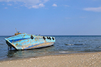 A boat that carried refugees abandoned on a beach.