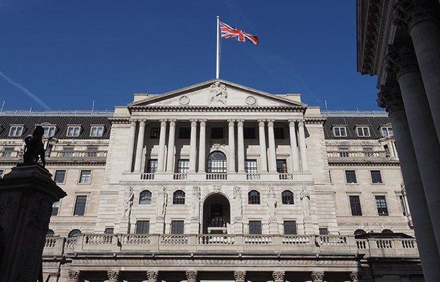 Front of the Bank of England with the Union Jack flying above it.