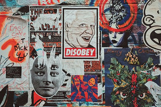 Graffiti and political stickers on a wall