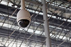A security camera hanging from a ceiling