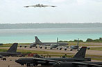 B-2 bomber taking off and B-52 bombers on the tarmac at the Diego Garcia Naval Support Facility, Chagos Archipelago in 2003.